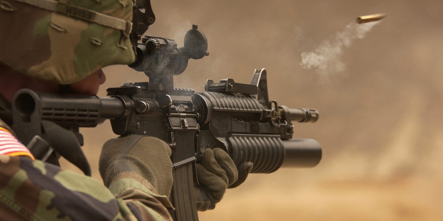 A soldier with a weapon in desert warfare