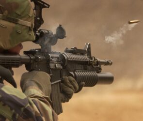 A soldier with a weapon in desert warfare